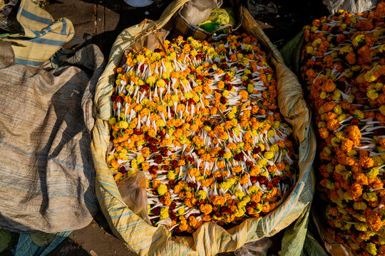 A large bag of marigold flowers for sale on the street in India