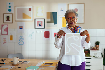 Portrait of female artist in modern workspace