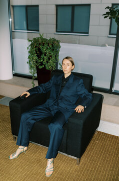 Androgyne woman wearing man classic suite  indoors