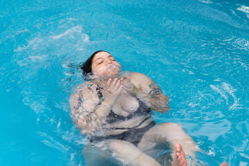 Having fun in the swimming pool in summer