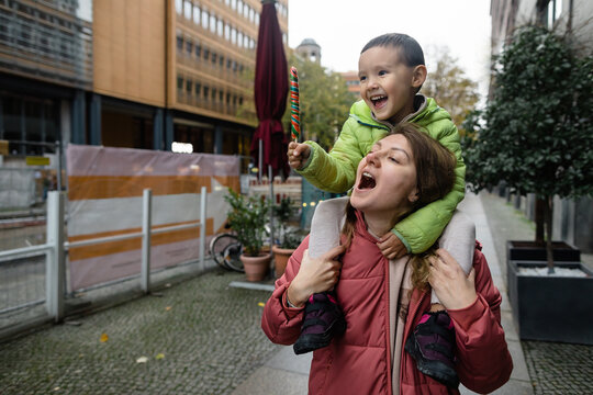 Woman and her little son playing on street