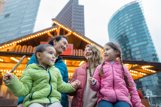 Husband and wife with kids at the Christmas market