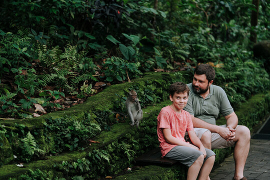 Dad and son in tropical park.