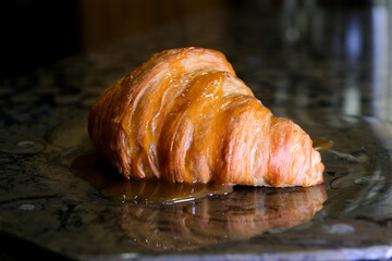 Fresh baked croissants. French croissants rotating on a black background. Fresh and tasty french breakfast. High quality Cut freshly croissant rotation in slow motion