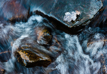 Flowing water on a river in winter.
