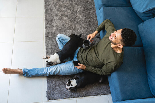 Man relaxing at home with his pets. 