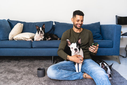 Image of a man with his pets in his home.
