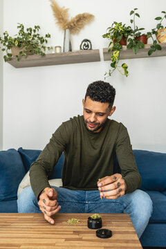 man preparing a marijuana cigarette
