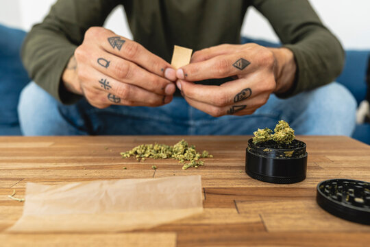 Hands of a man preparing marijuana  