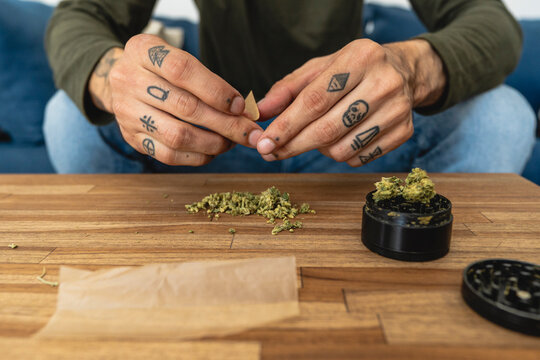Hands of a man preparing marijuana  