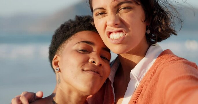 Lesbian, selfie and lgbt couple at the beach making silly faces for picture. Dating, love and young lesbian couple enjoying summer holiday by the sea having fun, smile and funny expressions together