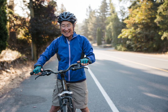 Woman riding her bike in bike lane in the morning.