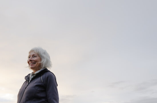 Active, healthy woman looking off into the distance outside.