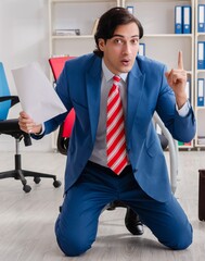 Young happy male employee in the office