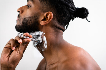 Man shaving in front of mirror