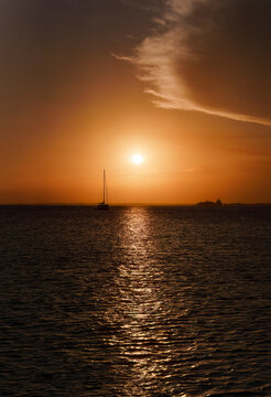 Sunset with sailboat in the distance