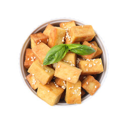 Bowl with delicious fried tofu, basil and sesame seeds on white background, top view