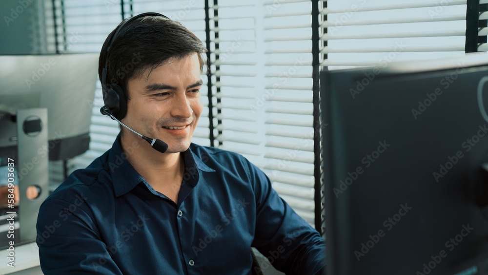 Aufkleber young competent asian male call center agent working at his computer while simultaneously speaking w