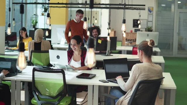 Startup business and entrepreneurship problem solving. Young AI programmers and IT software developers team brainstorming and programming in startup company share office space