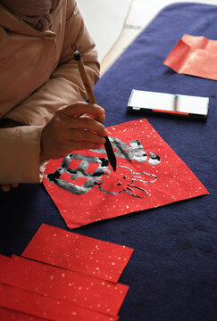 Make traditional Chinese New Year brush calligraphy decorations