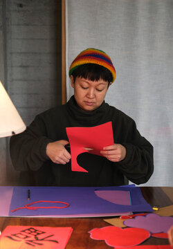 Asian woman making traditional Chinese New Year decorations