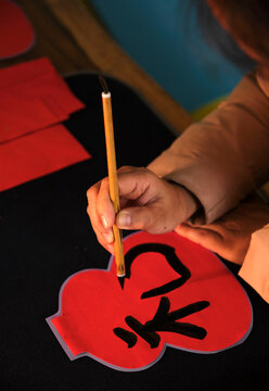 Make traditional Chinese New Year brush calligraphy decorations