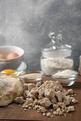 Different types of yeast, eggs, flour and dough on wooden board