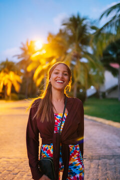 Positive Cuban woman on illuminated street at night