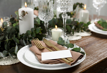 Luxury table setting with beautiful decor and blank card. Festive dinner