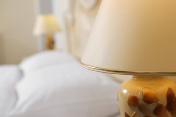 Stylish lamp in bedroom, closeup. Space for text