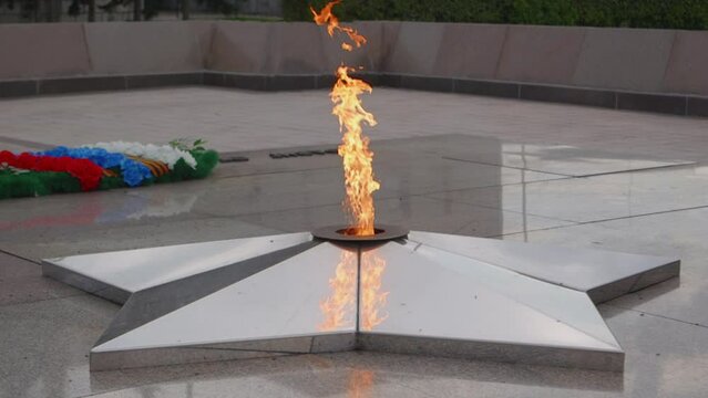 War memorial of eternal flame in memory of the war. War memorial in form of an eternal flame burning in the center of a five-pointed star. Concept of military monuments and memorials