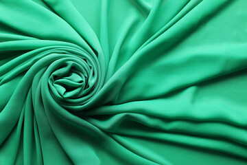 Obraz premium Beautiful green tulle fabric as background, top view