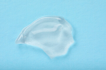 Smear of ointment on light blue background, top view