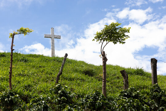 Single Christian Cross on Hill Outdoors in summer 