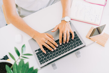 Anonymous woman typing on laptop keyboard