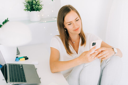 Woman distracted from work using phone