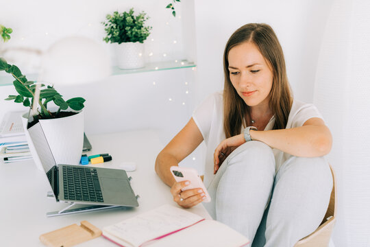 Woman having break from work using her phone