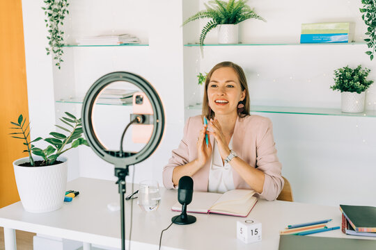 Female video blogger recording content at home studio