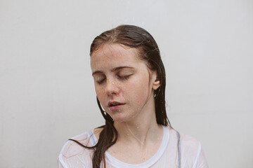 Woman with wet hair under the rain