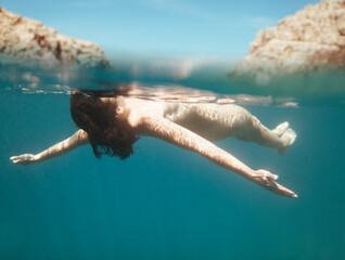 Anonymous woman floating in the sea