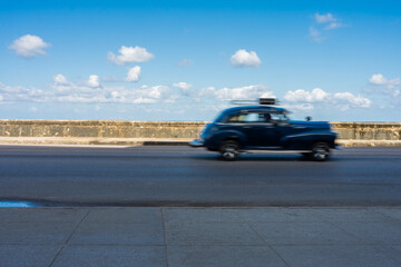 Antique Black Car Driving On A Malecon Highway