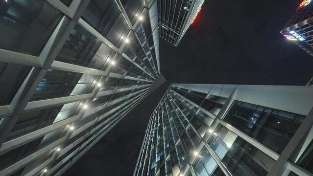 Low angle view of skyscrapers in city at night