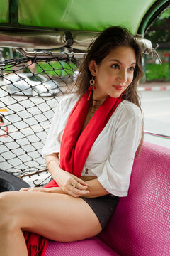 A woman gets a tuk-tuk to move around in the city