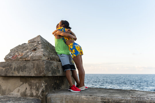 Young Couple Hugging On A Pier