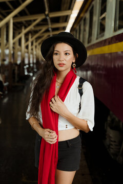 A stylish woman at the train station