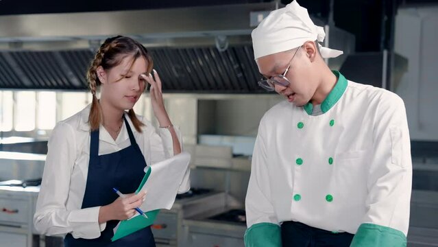 4K, Beautiful asian student who learns cook become a future chef, standing and learning prepare ingredients with a chef who specializes in all types of food both practice and theory.