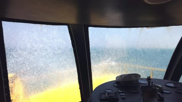 Marine navigational officer cruising during navigational watch on Bridge . Work at sea