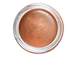 Glass jar with tasty delicious salted caramel, top view