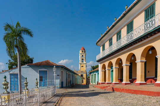 A Church Tower At The End Of A Cobbled Street