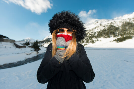 Woman covered with winter clothes at snow scenery